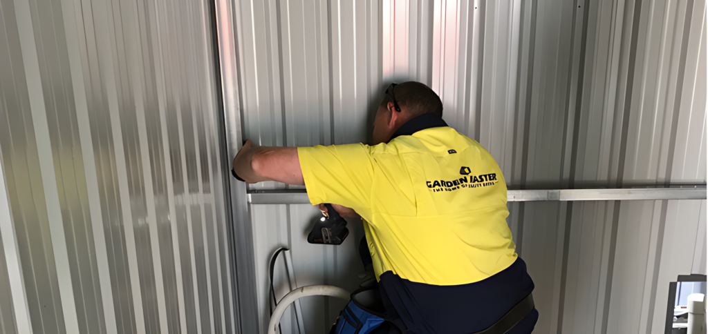 Image of a man wearing a yellow shirt performing a shed installers near me
